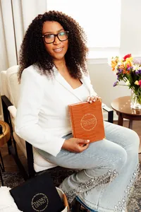 woman holding her the year of thanksgiving journal in color cognac