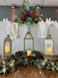 Whimsical moody wedding reception headtable at our Clearwater, Florida event venue, The District - Inclusive decor package featuring moss greenery and fairytale lanterns for a magical atmosphere