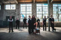 A band standing together in an empty building