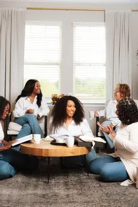Photo of grou of women having a bible study talking and smiling.