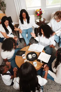 group of women gathered in a circle praying together