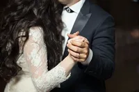 Close-up of a couple holding hands while dancing