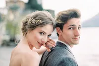 bride-hugs-groom-shoulder-from-portrait