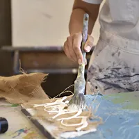 Andrea_Cermanski_painting_with_burlap_in_her_Santa_Fe_studio_Canyon_Road