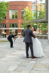 A videographer recording a newlywed couple