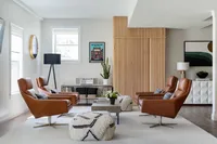 Modern Living Room project designed by Glass House Design Group in Boston. Brown leather chairs with cozy fur textures and wood furniture. Effortlessly chic New England interior design that works for real life.