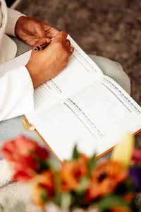 woman writing in her the year of thanksgiving journal