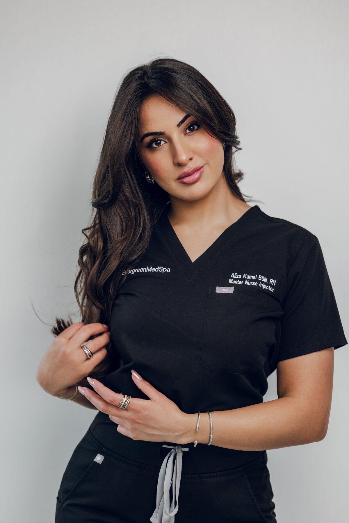 Team member in black scrubs posing for a portrait