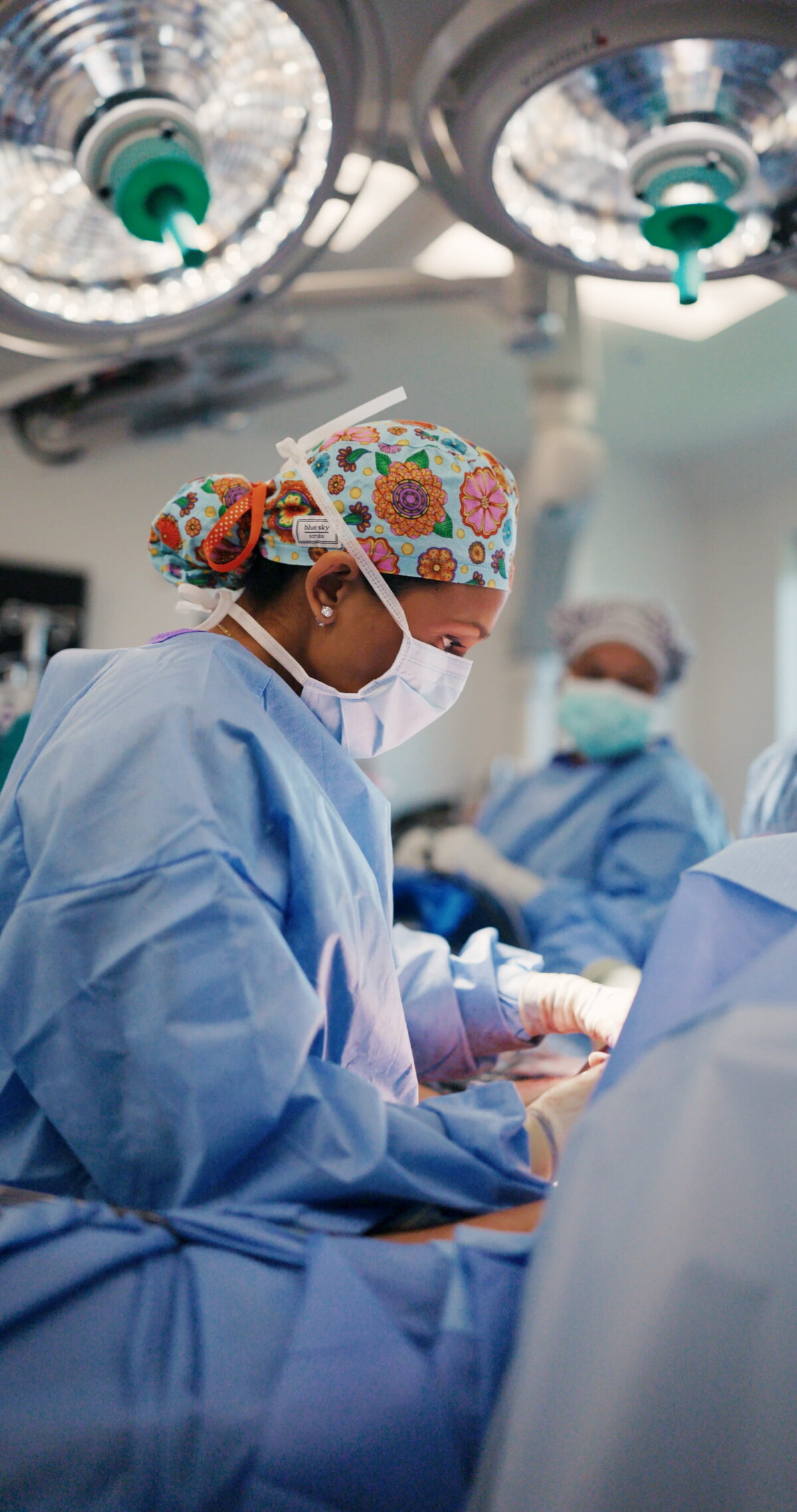 Surgical team at work under operating room lights