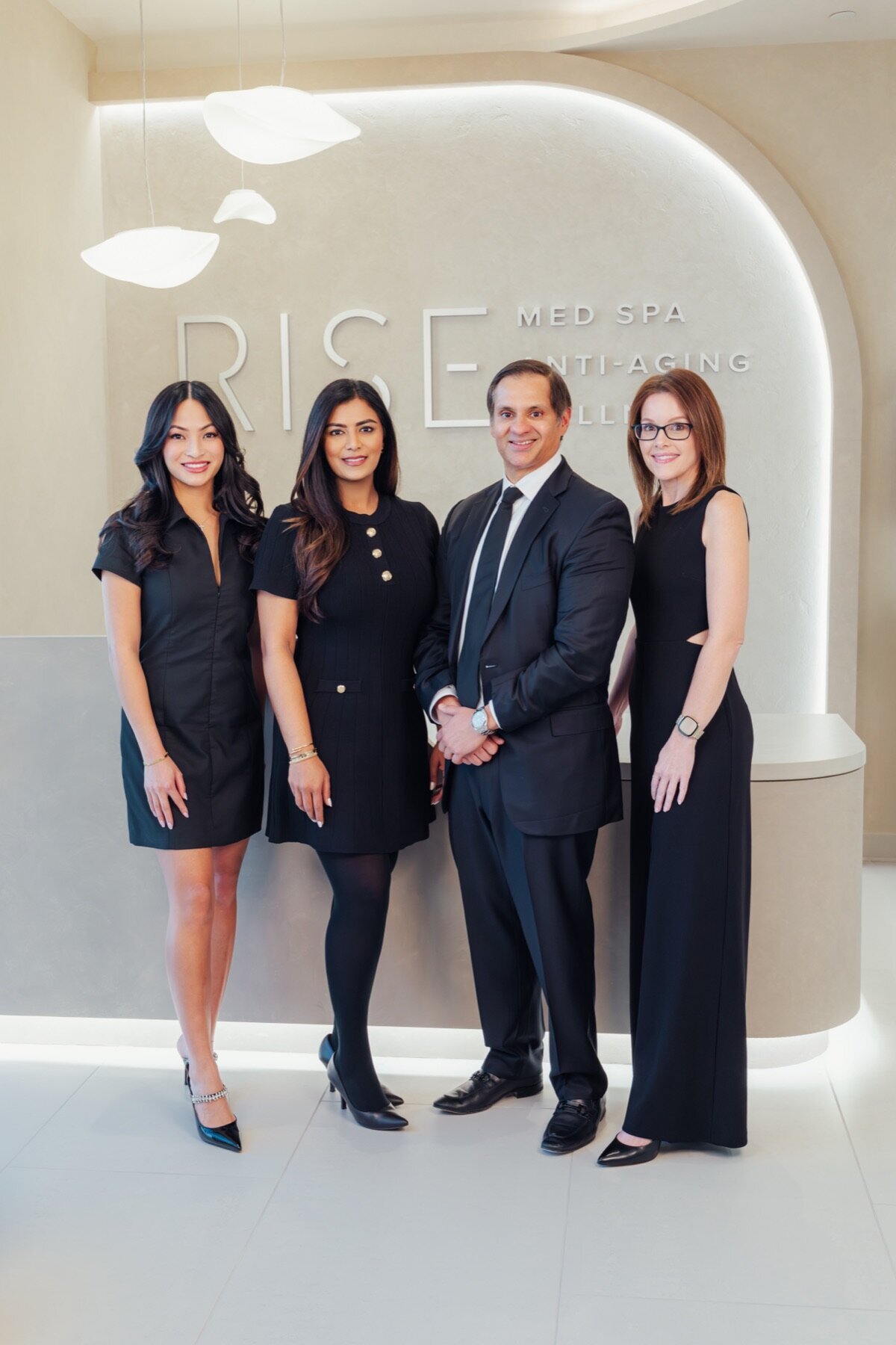 Four Body by Ravi team members standing together in the lobby