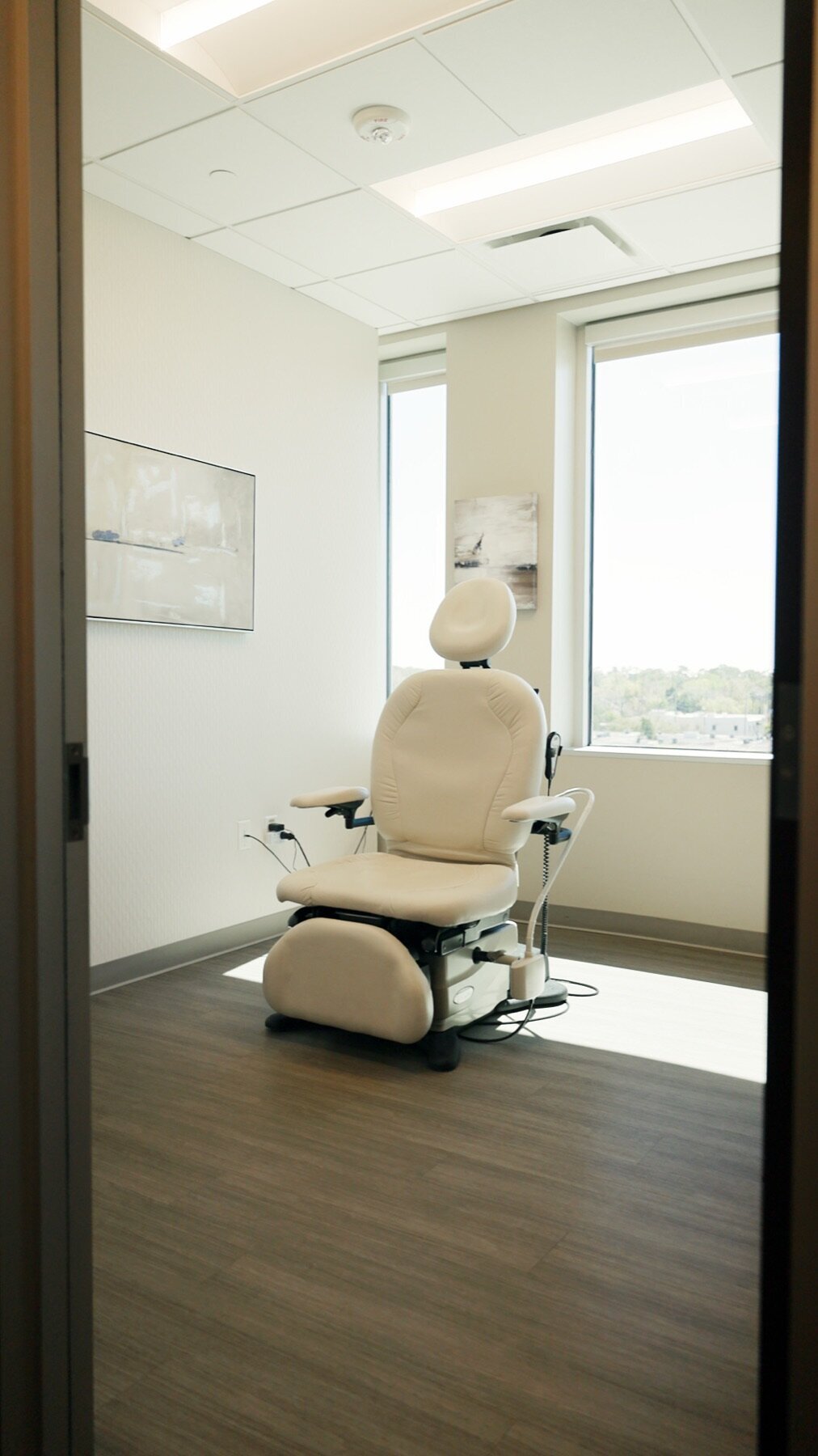 Exam room with a treatment chair by a window