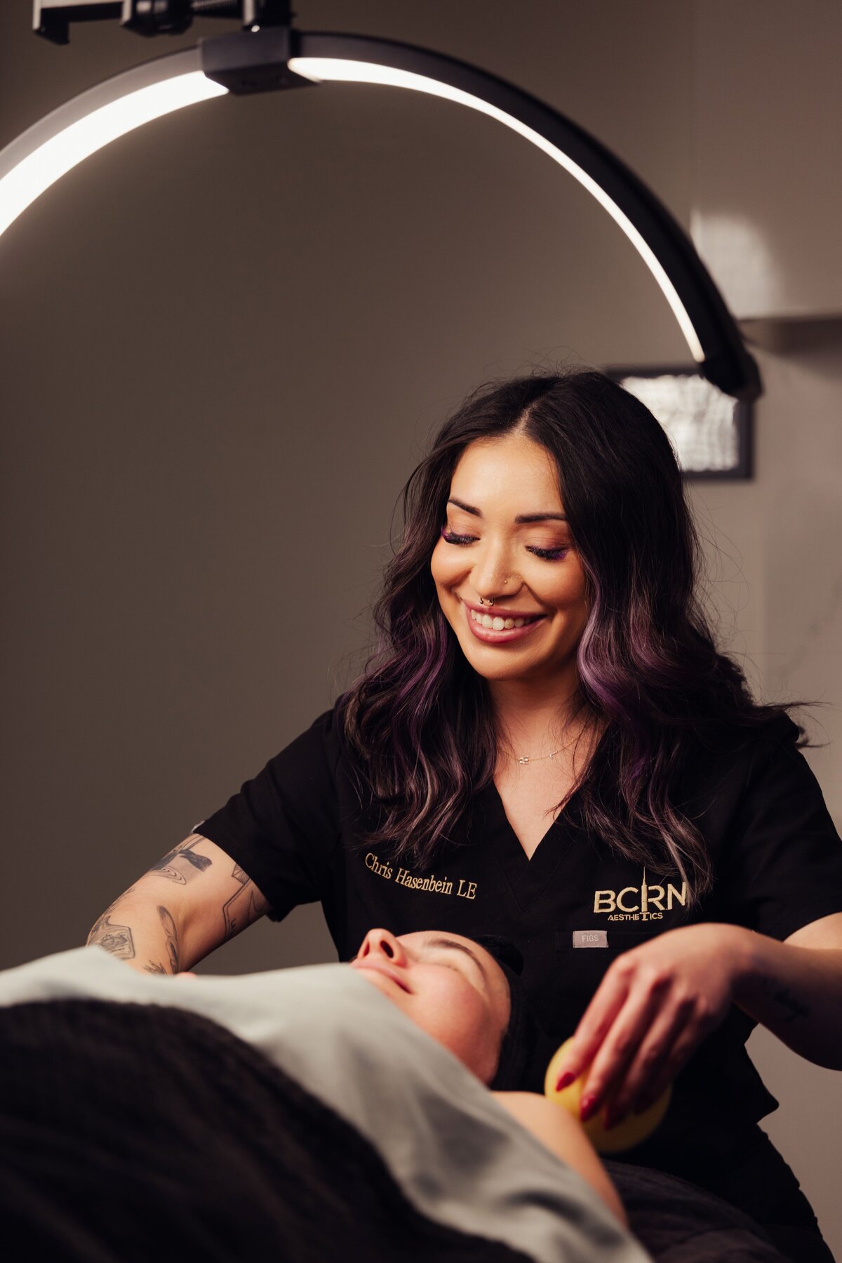 Smiling provider giving a facial at BCRN Aesthetics