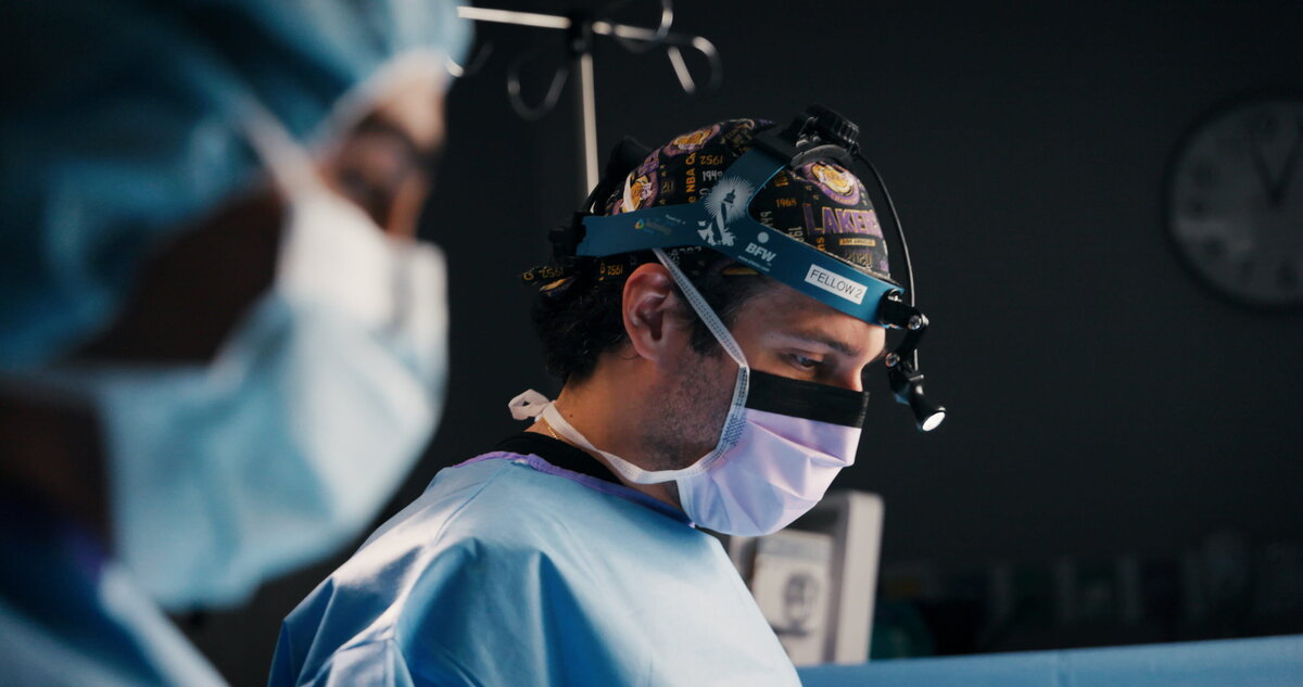 Surgeon and assistant in masks during a procedure