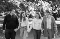 fallback shared on Invalid Date | Black and white photograph by Suzy Slemen Photography capturing a family of four walking...