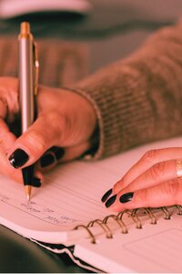 woman-writing-black-nails
