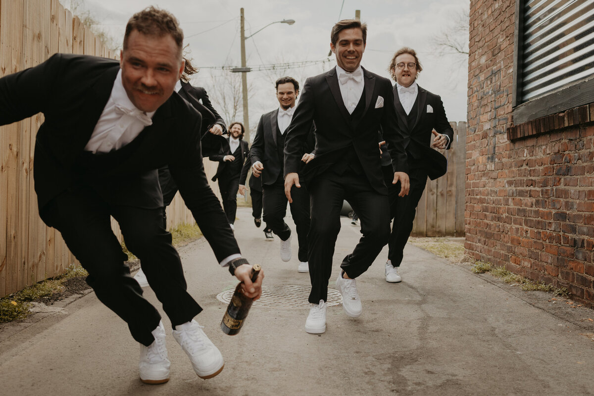 groomsmen race to get a bottle of whiskey