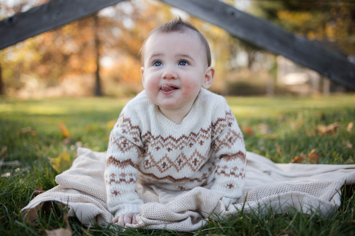 baby girl in a cozy sweater smiling