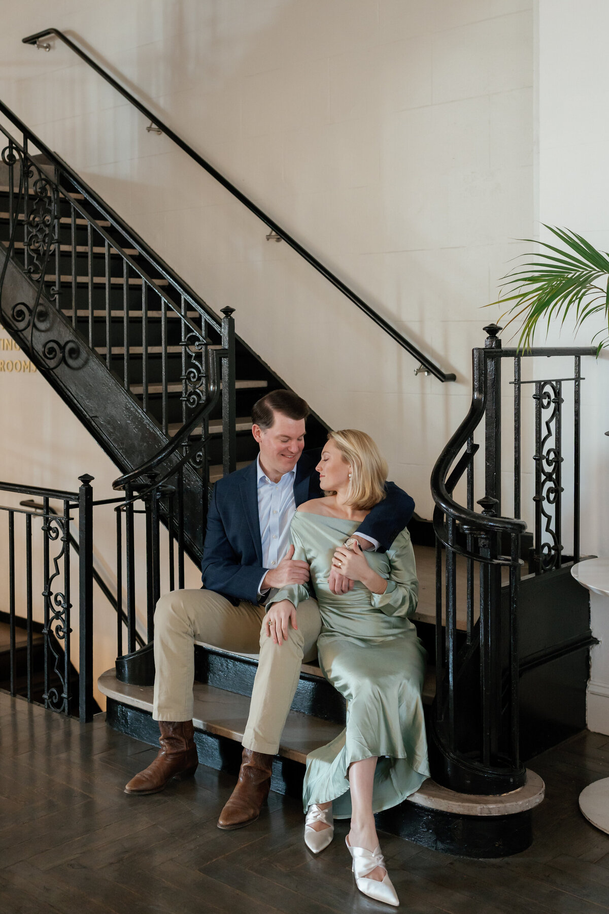 Quirk Hotel Richmond Photos | couple sitting on the grand staircase in the lobby of Quirk RVA