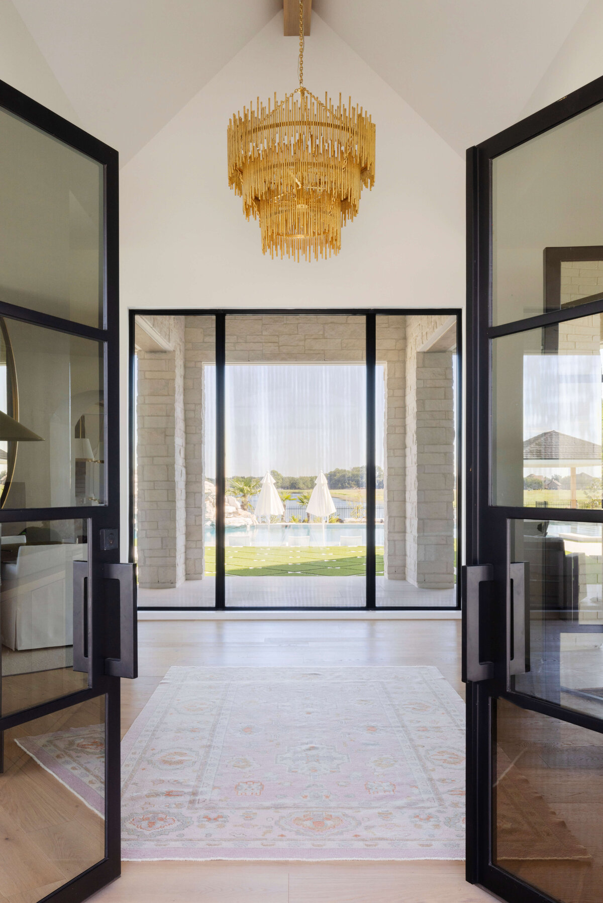 oyster creek studios hughes gold chandelier and black framed windows