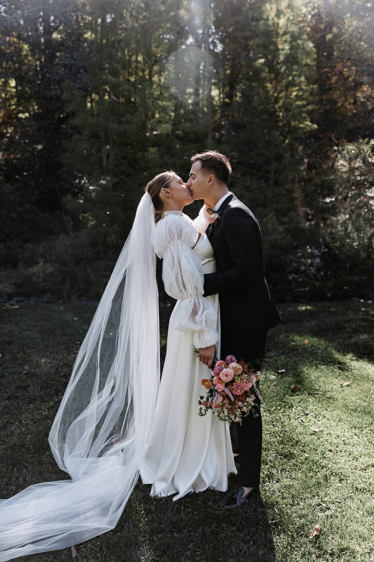 Elopement Photography, bride and groom kissing while bride holds her flowers