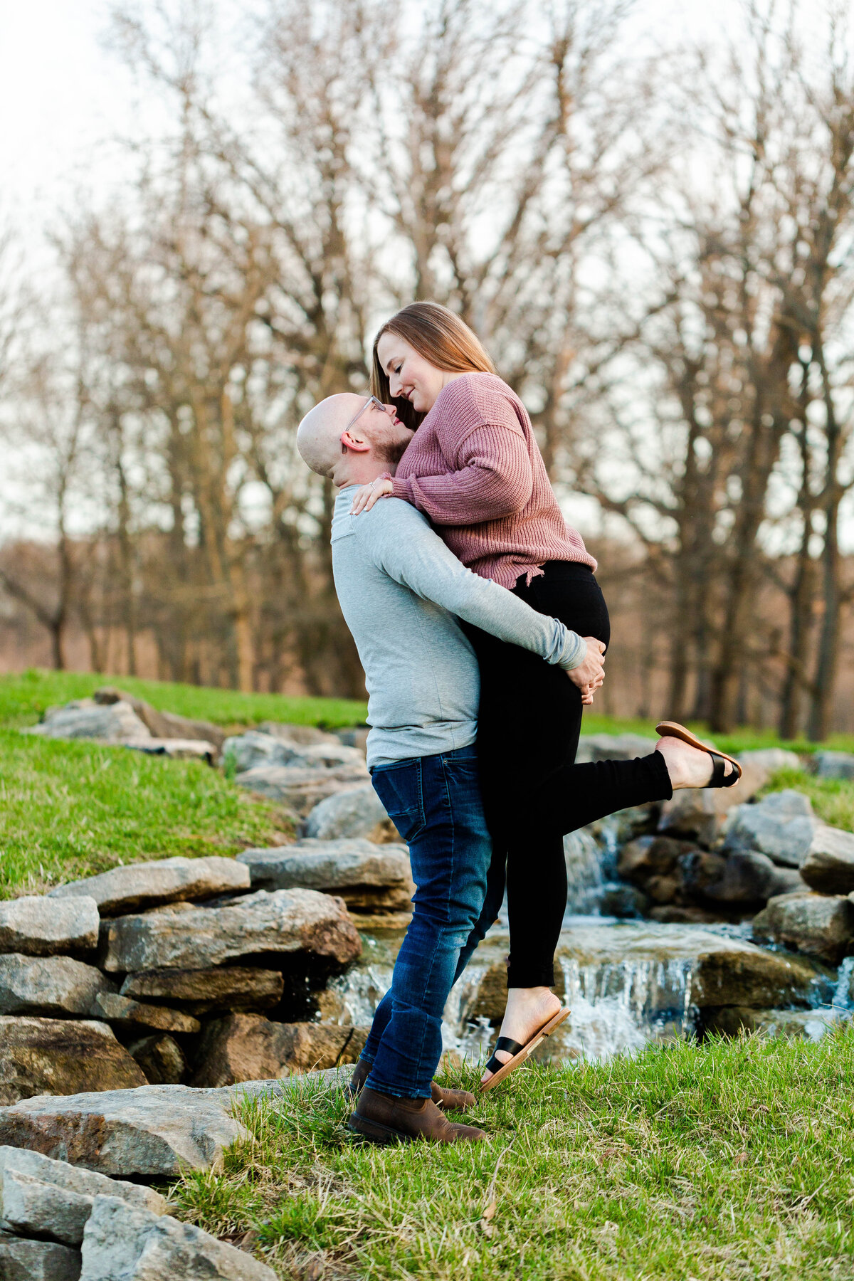 Romantic 'Spin Around Amazed by Your Love' engagement photo captured by Style & Grace Photography in Vandalia, MO, showcasing the couple’s joyful and loving connection.