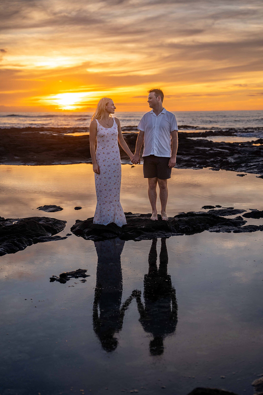 Couple looking at each other during sunset for Hawaii engagement photos