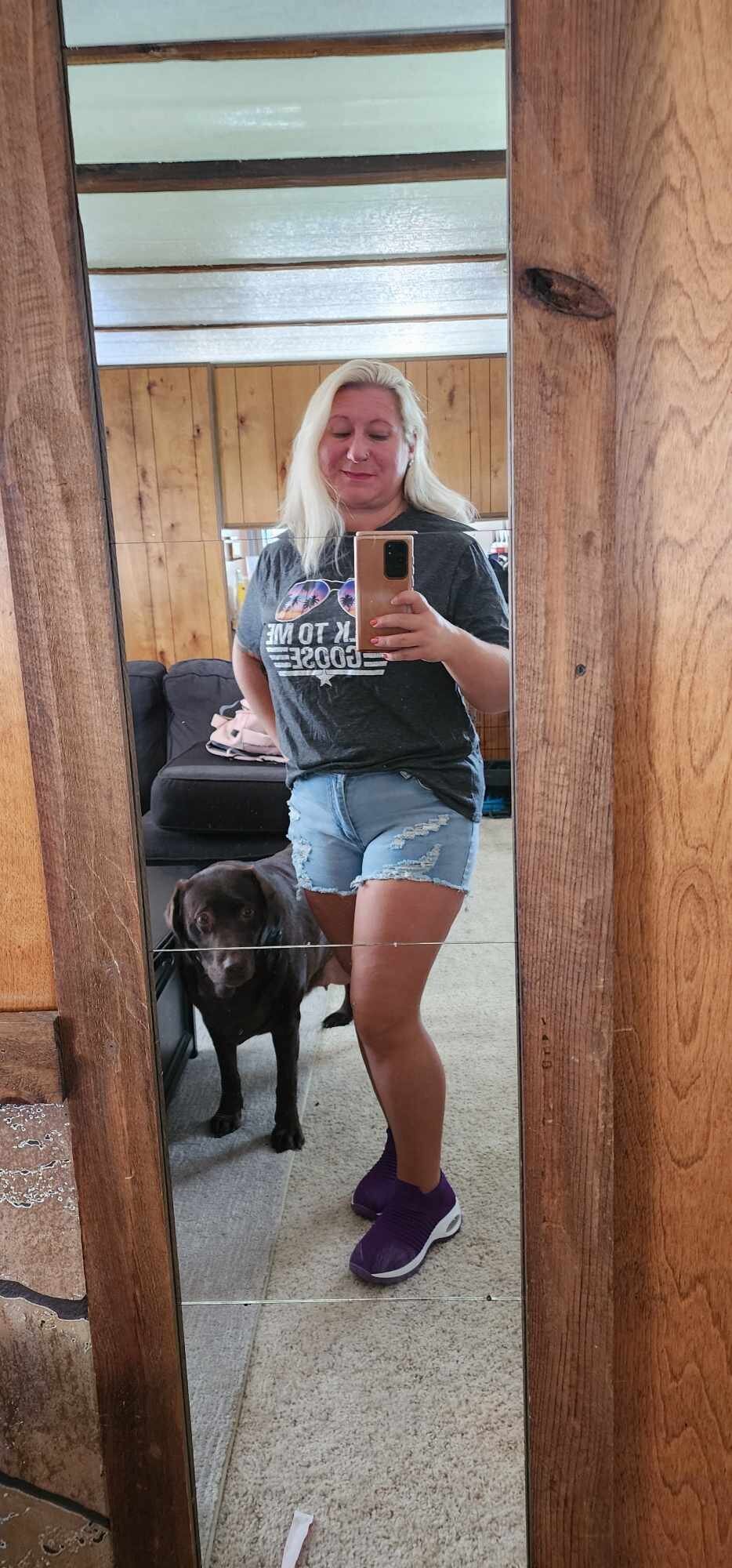 a woman takes a selife in the mirror
