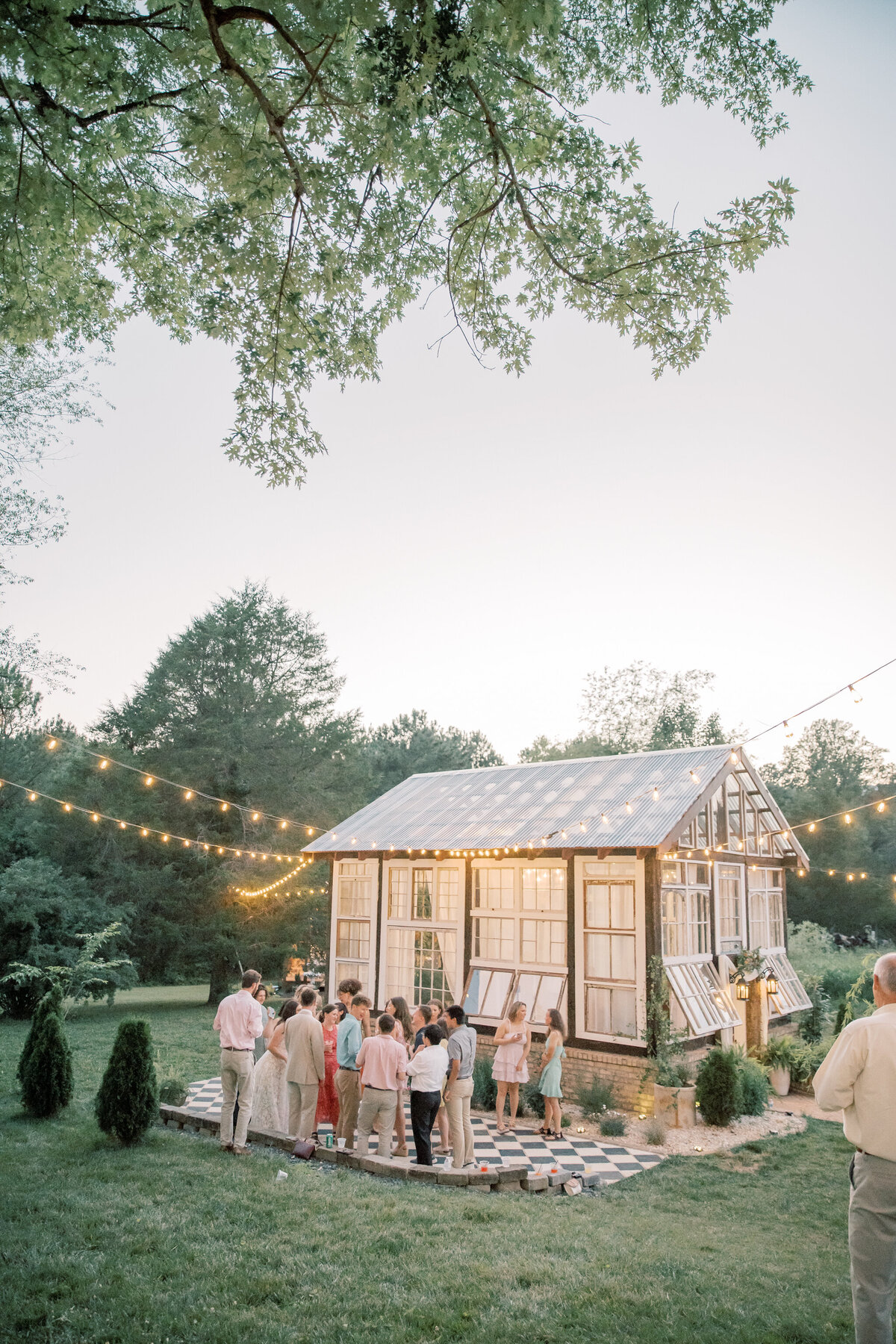 Three Oaks Manor Wedding | greenhouse and dance floor full of guests at wedding reception