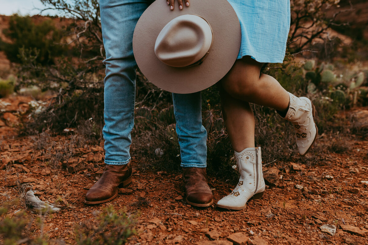 couple standing together with cowboy hat