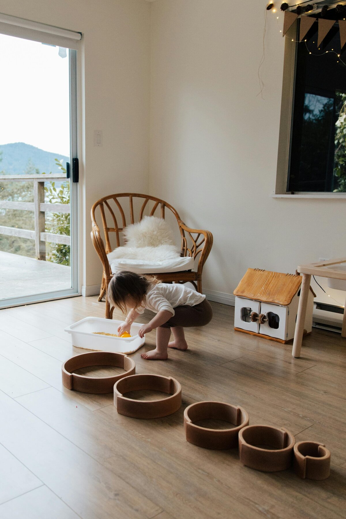 Natural tone Wooden rainbow toys arranged in circles on floor | Rooted Within whole-child educational evaluations Santa Barbara