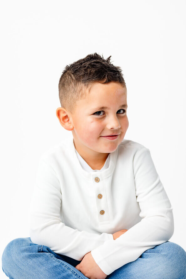 Boy flirts with camera during his photo session.