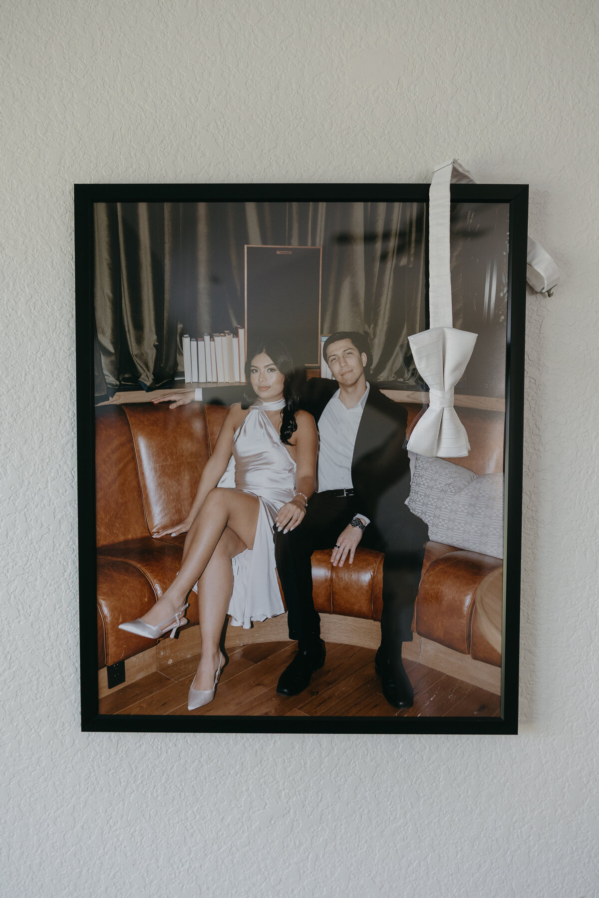 Framed engagement portrait displayed in a getting-ready suite as part of meaningful wedding day details, adding a personal touch to the couple's pre-ceremony decor.
