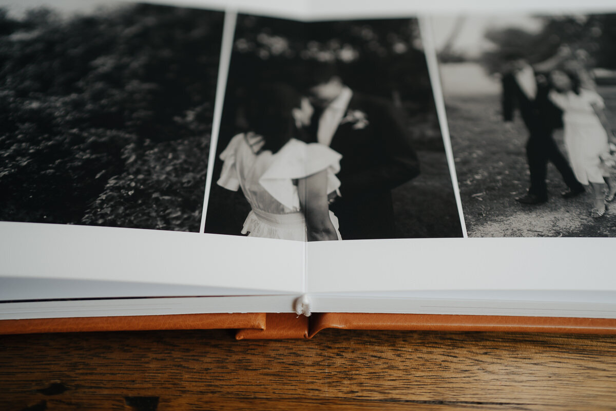 black and white printed pages on a tan eco leather fine art wedding album