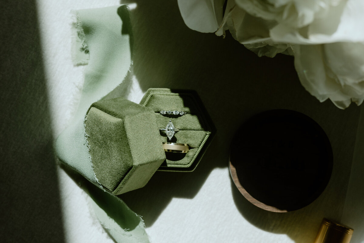 Editorial flat lay of bridal accessories with mountain-inspired details