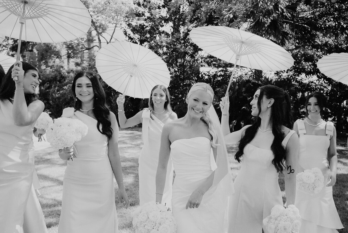 Bride and bridesmaids with southern parasols at Charleston wedding