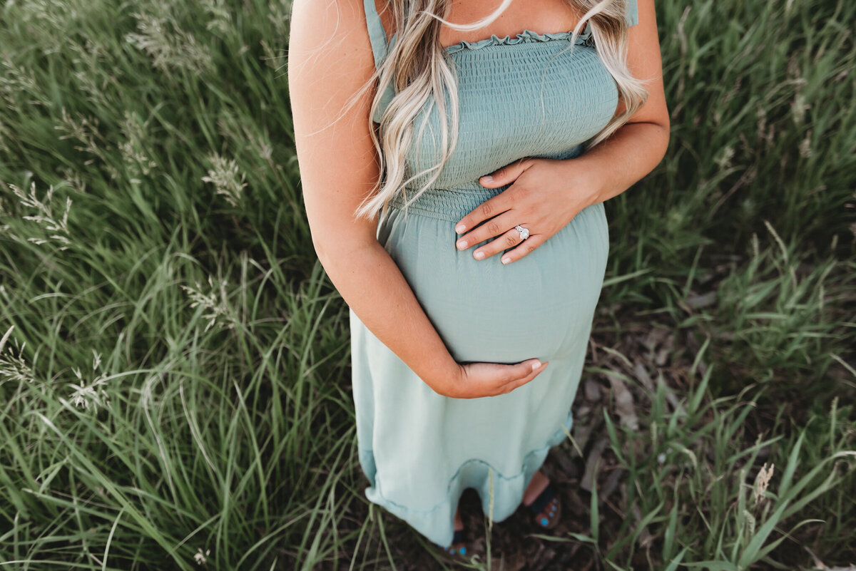 A close up overhead shot of a mommas baby bump during the Maternity session near Bismarck in the General Sibley park.