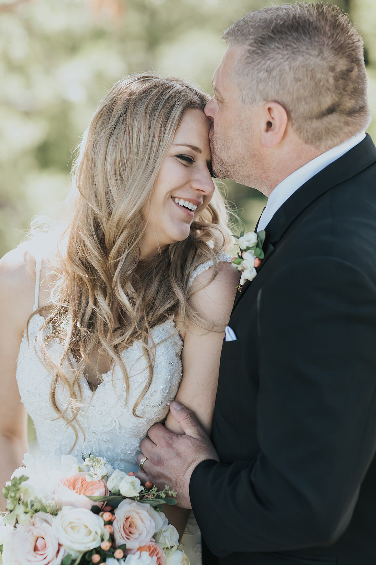 tunnel mountain hoodoos banff wedding groom kissing bride's forehead