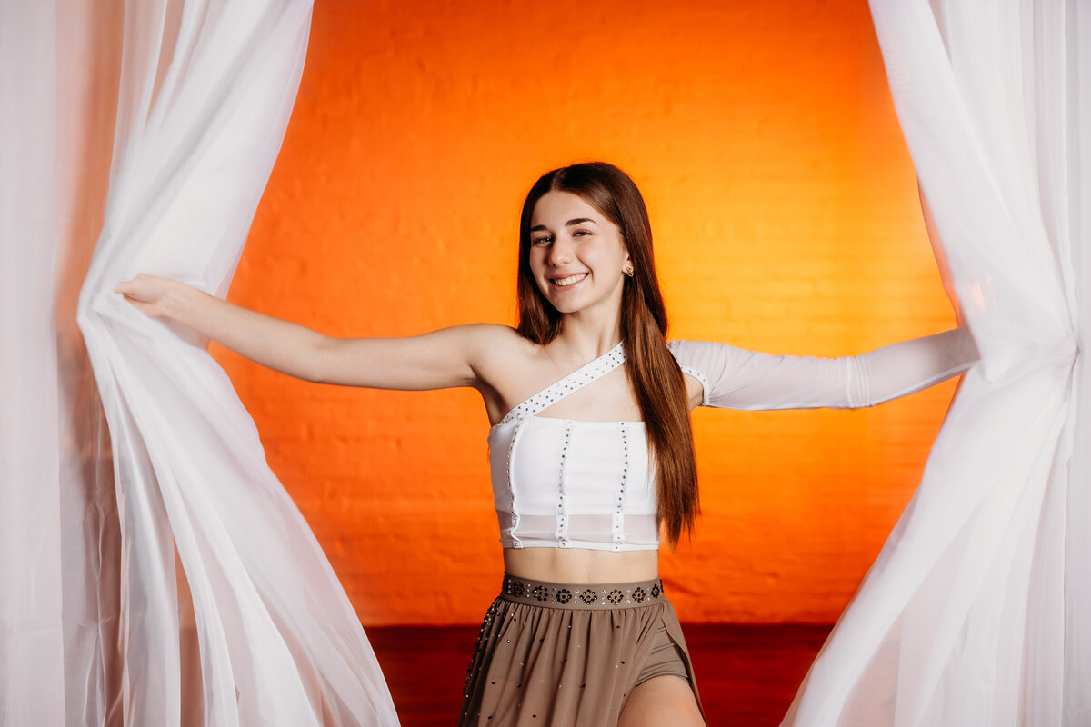 Ionia teen poses in studio for a photoshoot in her dance uniform.