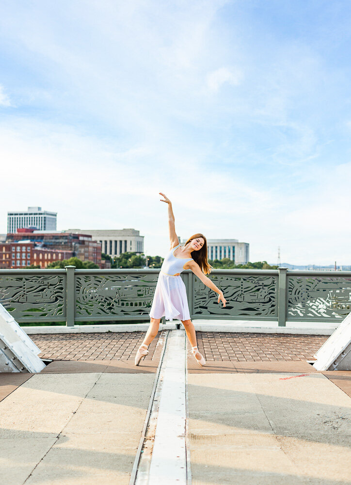 Dancer elegantly posing on a bridge