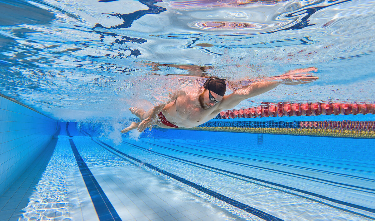 commercial photo of Tafe Queensland academy of sport student swimming in pool