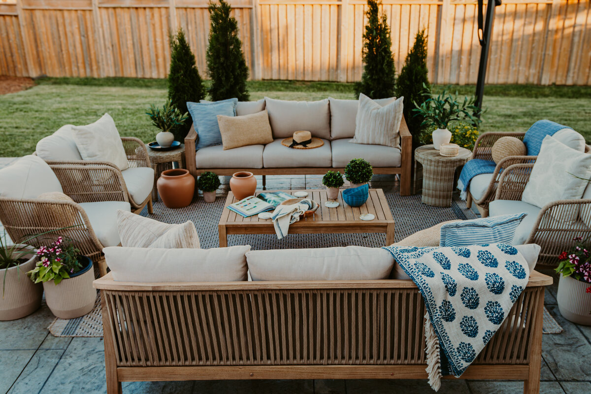 backyard patio with two sofas and accent chairs with coffee table in the center