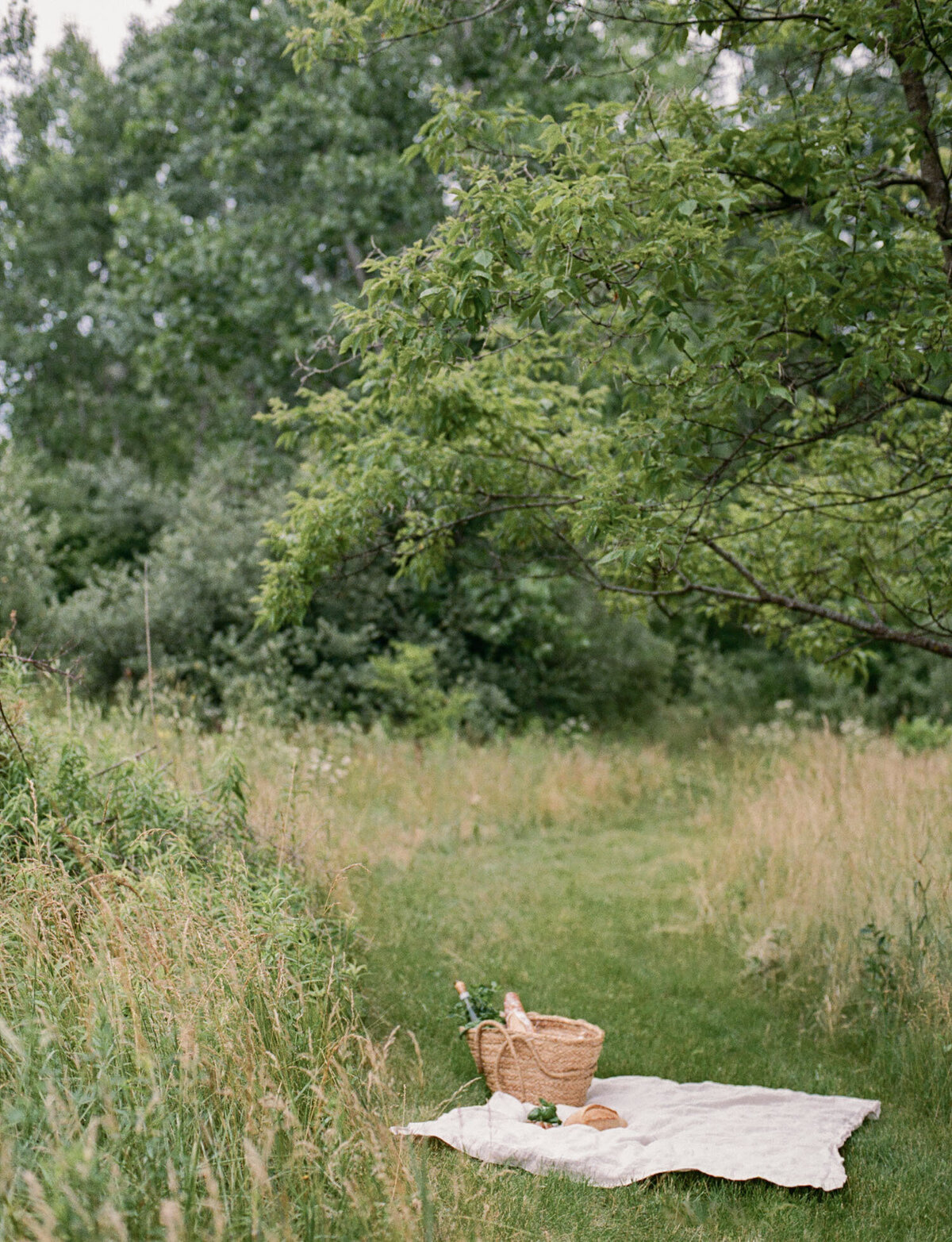 straw market tote and linen blanket, meadow picnic, film branding lifestyle photography for Detroit Rose candles