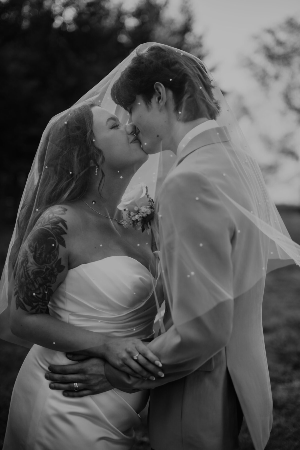 bride and groom kissing under veil in black and white, amarillo texas wedding photography 