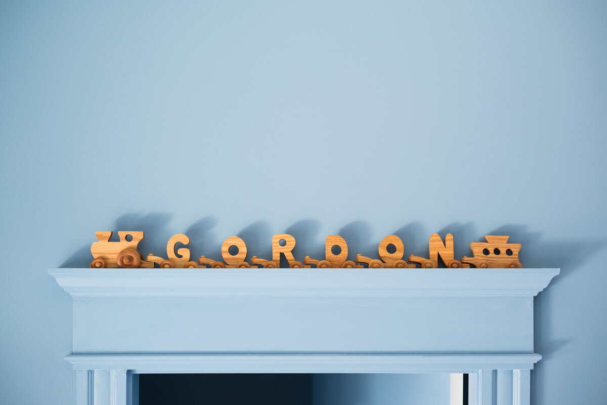 melinda chesson interiors west 7th street nursery wooden train on shelf that spells gordon