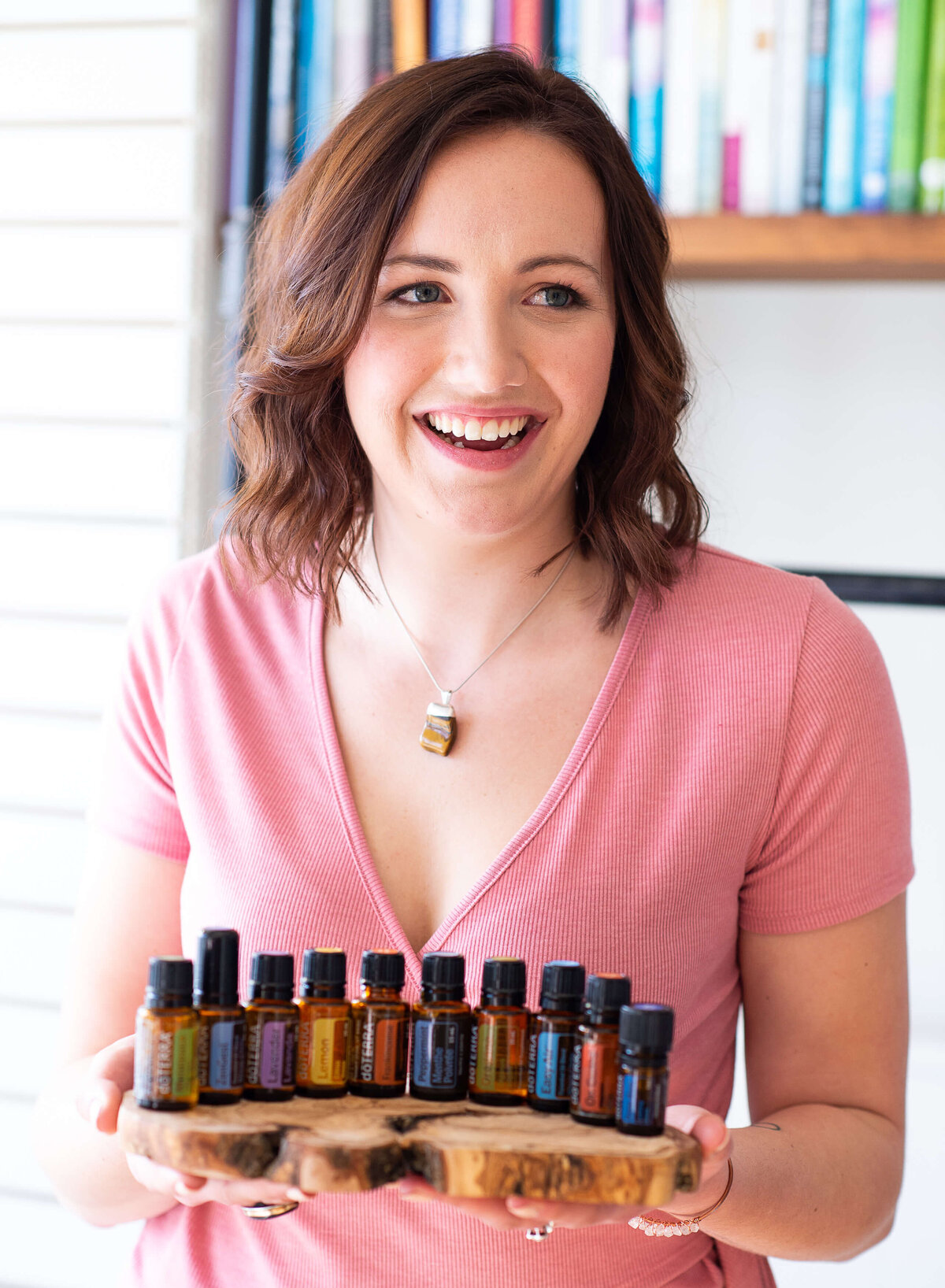 Ottawa branding photography showing a DoTerra wellness advocate holding a tray of assorted popular essential oils.  Captured in the yoga studio by JEMMAN Photography COMMERCIAL