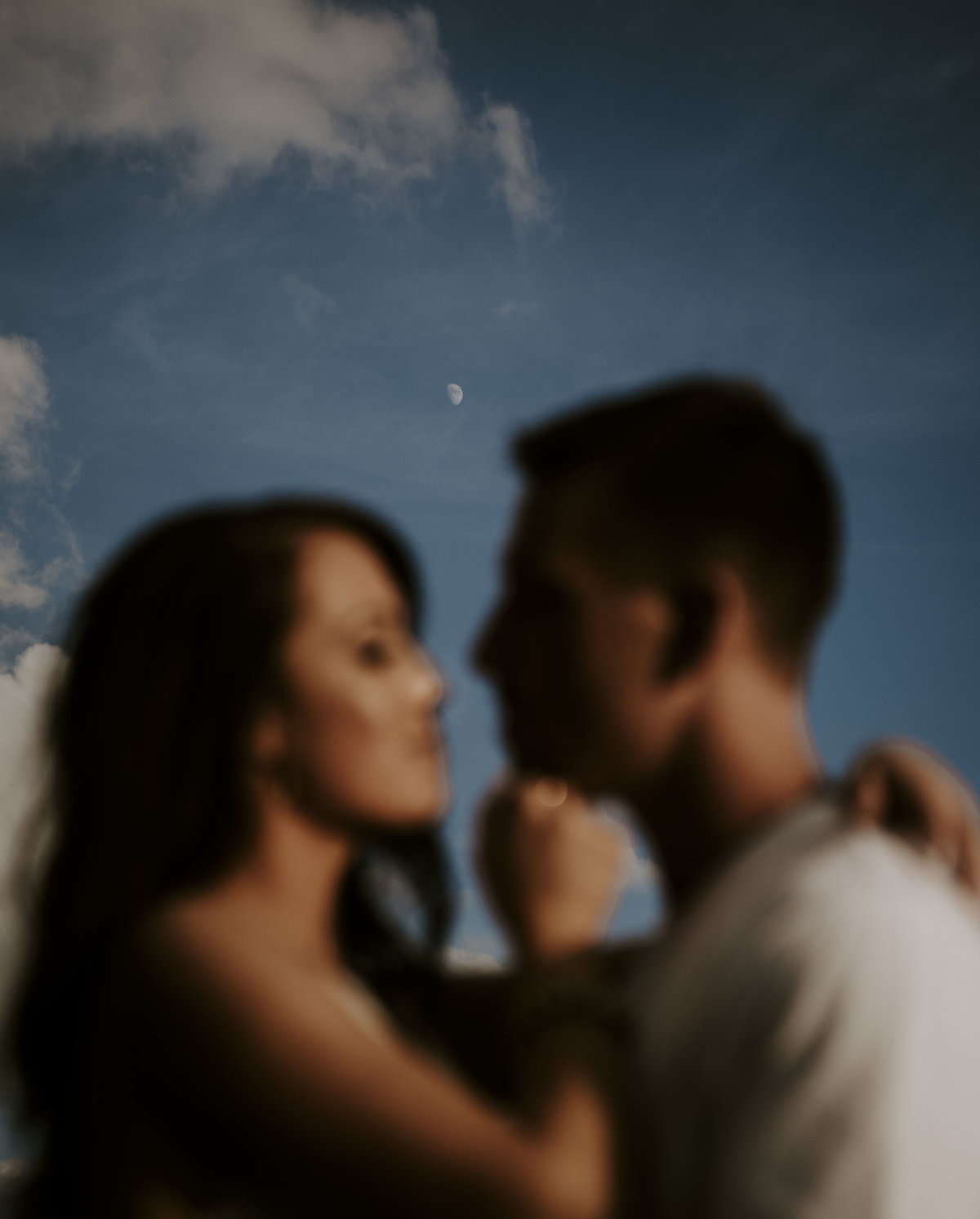 Couple kissing with the moon in the background near Asheville NC