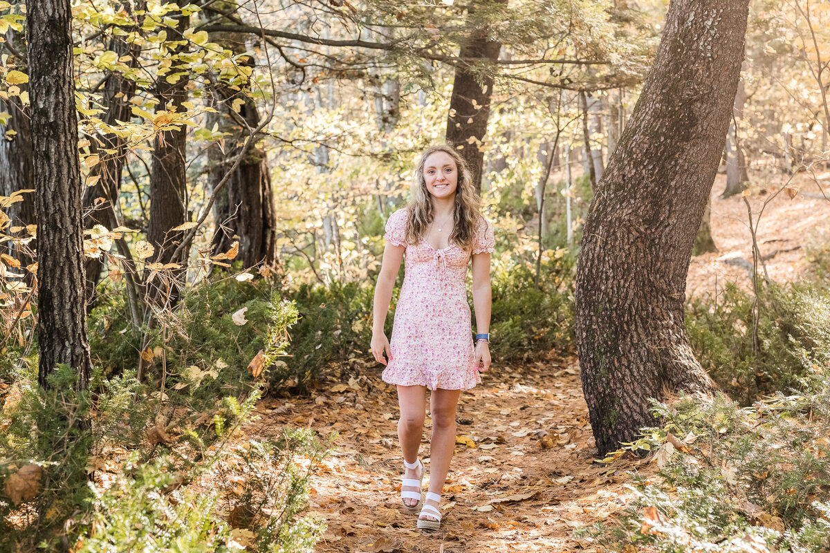Concord High School senior walking in woods at Sewalls Falls in Concord NH by Lisa Smith Photography