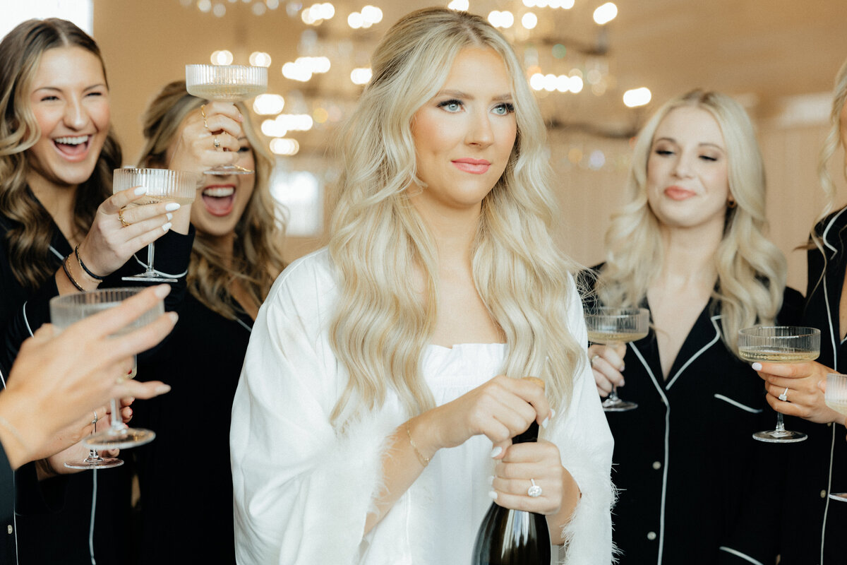 The bride popping the champagne.