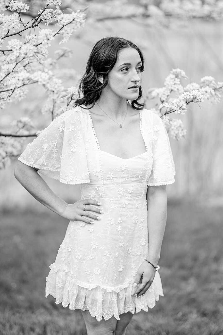 Black and white photo of young woman and flowers