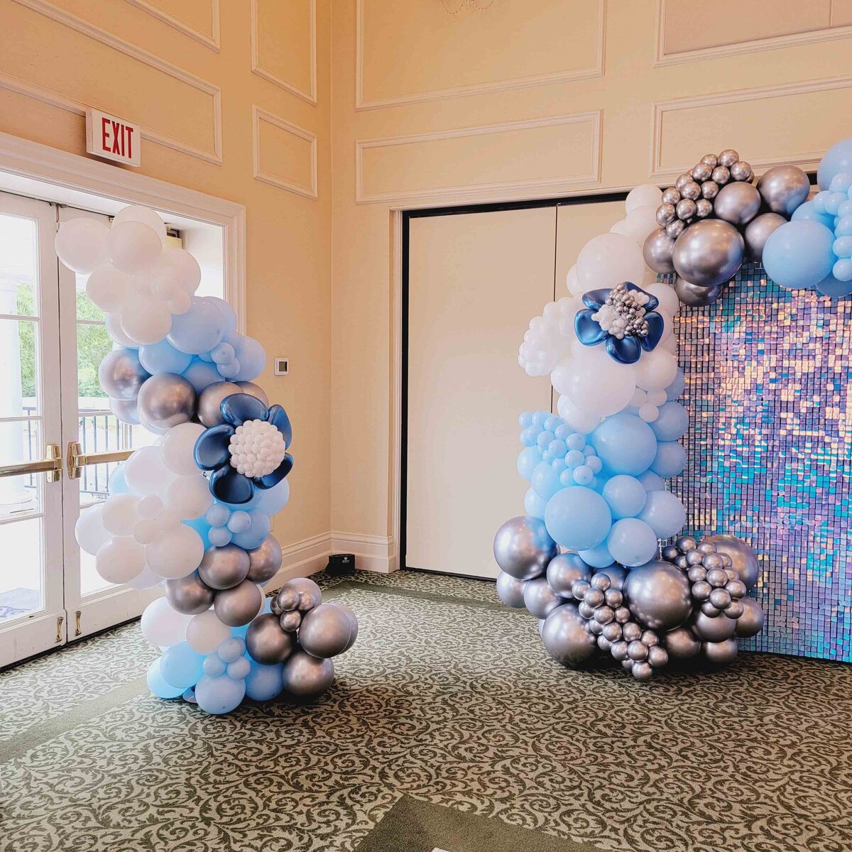 The celebration with Air with Flair Decor's Custom Balloon Installation, featuring the elegance of Blue Flowers and Bright Party vibes